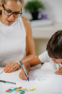 Midsection of woman holding paper with text on table