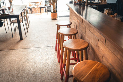 High angle view of empty chairs and table in restaurant