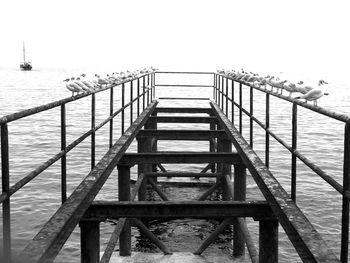 Pier over sea against clear sky