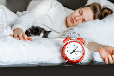 Midsection of woman sleeping on bed