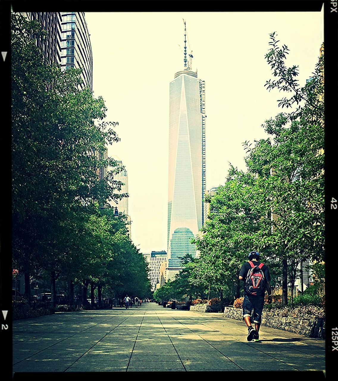 building exterior, architecture, built structure, city, tall - high, transfer print, skyscraper, tower, tree, clear sky, office building, auto post production filter, modern, street, tall, building, road, the way forward, growth, city life