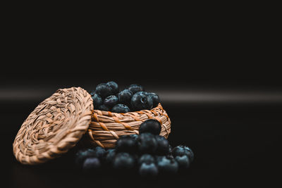 Close-up of fruits on table against black background