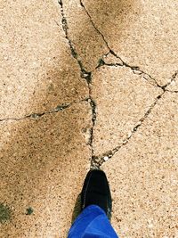 Low section of person standing in the dark