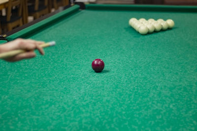 Midsection of woman playing pool