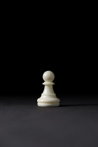 Close-up of chess pieces on black background