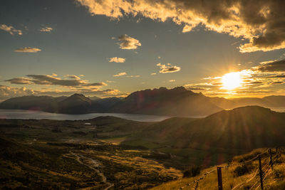 Scenic view of dramatic sky over landscape during sunset