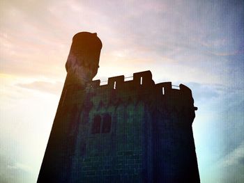 Low angle view of building against cloudy sky