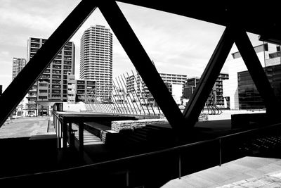 Modern building against sky seen through glass window