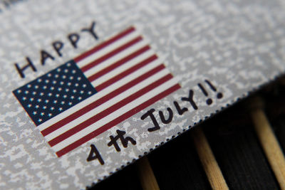High angle view of american flag with text on paper