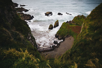 High angle view of rocks on sea shore