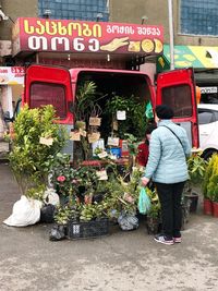 Rear view of people at market stall