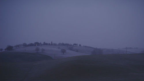 Scenic view of landscape against clear sky during winter