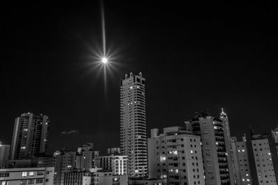 Low angle view of skyscrapers lit up at night