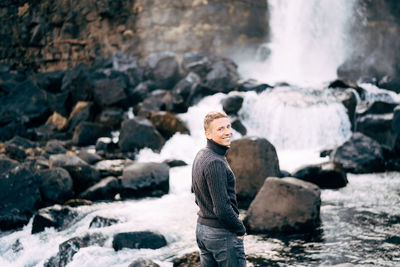 Portrait of man standing on rock