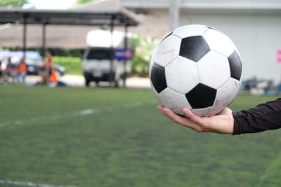 Cropped hand holding soccer ball