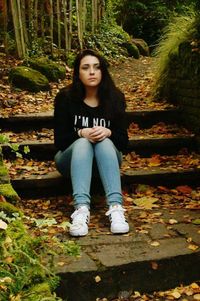 Portrait of young woman sitting outdoors