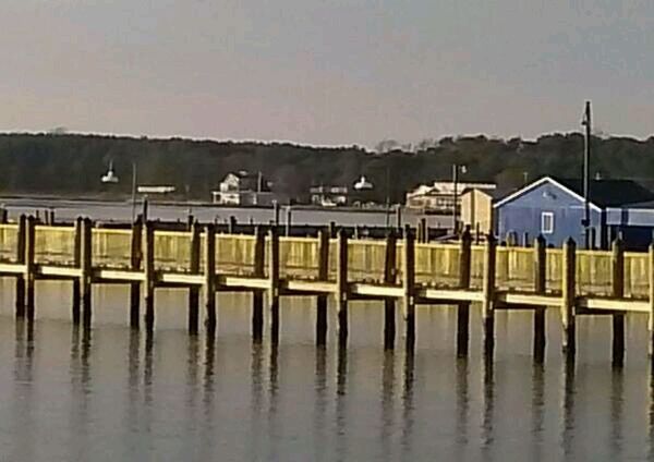 water, built structure, pier, architecture, waterfront, wood - material, reflection, lake, tranquility, tranquil scene, building exterior, sea, sky, nature, mountain, wooden post, in a row, outdoors, day, wooden