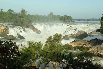 Scenic view of waterfall against sky