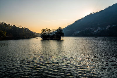 Scenic view of lake against sky during sunset