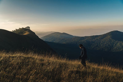 Man on mountain against sky