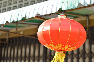 Close-up of lantern hanging against blurred background