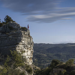 Men standing on top of a cliff