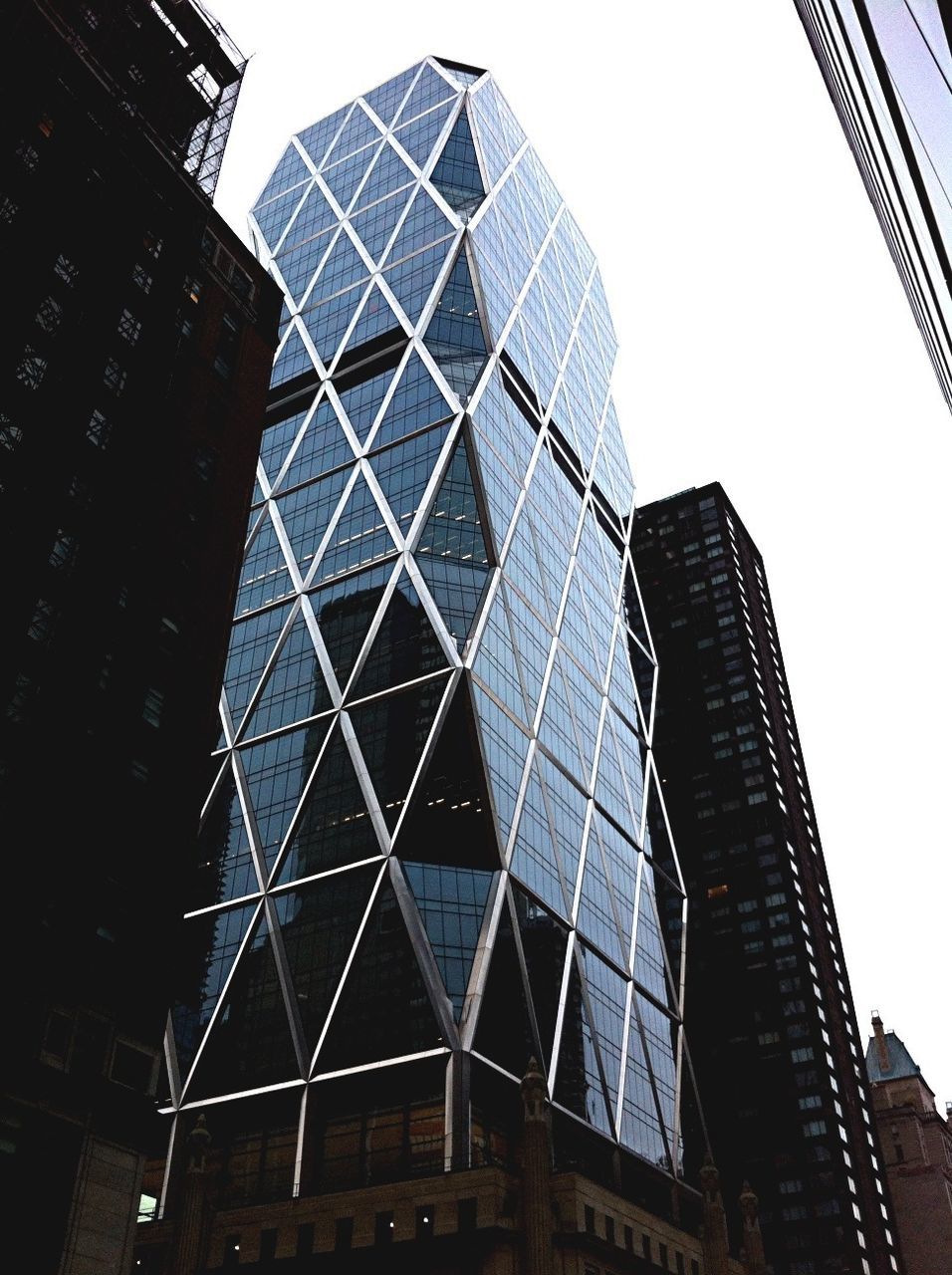 architecture, building exterior, built structure, low angle view, modern, skyscraper, office building, tall - high, city, tower, glass - material, reflection, clear sky, building, capital cities, sky, tall, city life, day, travel destinations