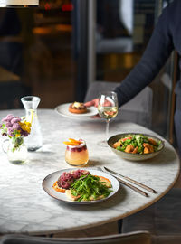 Midsection of woman having food on table