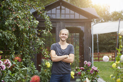 Portrait of male gardener with arms crossed smiling in yard