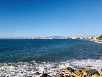 Scenic view of sea against clear blue sky