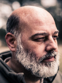 Close-up of bearded man looking away