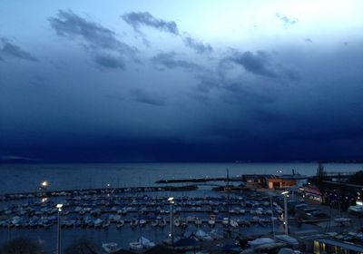 View of harbor against cloudy sky