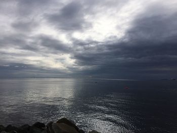 Scenic view of sea against cloudy sky