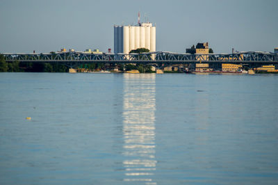View of bridge against industrial buildings