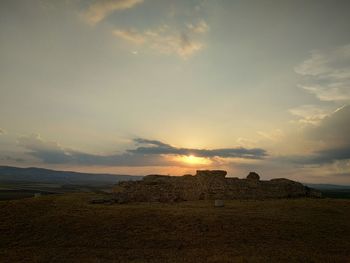 Scenic view of field against sky during sunset