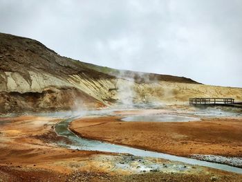 Scenic view of waterfall against sky