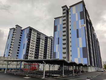 Low angle view of modern building against sky in city