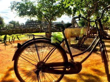 Bicycle wheel against trees