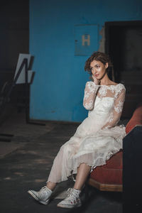 Portrait of woman sitting on floor