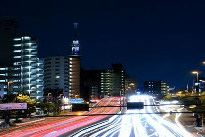 Light trails on road in city at night