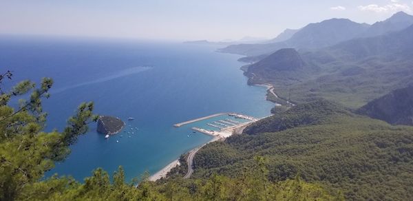 High angle view of sea and mountains against sky