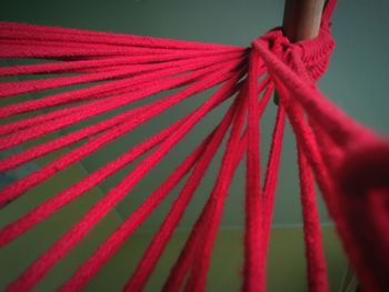 Close-up of red strings tied to pole