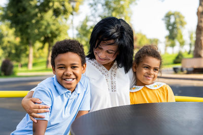 Portrait of happy friends standing in park