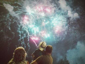 Low angle view of firework display at night