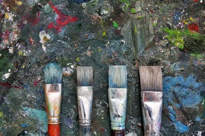 Close-up of paintbrushes on dirty table