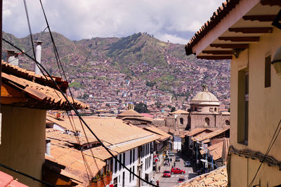 A view of a street and the old town of cuzco spread on the hills, peru
