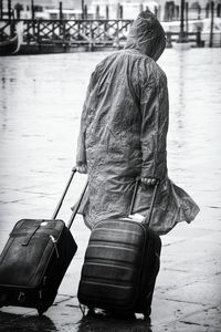 Rear view of man with luggage