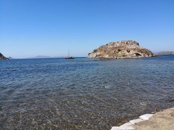 Scenic view of sea against clear blue sky