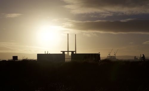 Silhouette built structure against sky during sunset