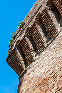 Low angle view of old building against blue sky